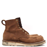A brown suede lace-up work boot with brass eyelets, contrast stitching, and a pull tab, shown from a side profile on a white background.