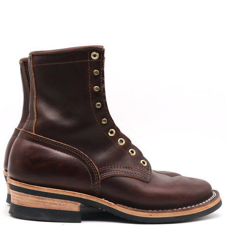 A dark brown leather lace-up ankle boot with brass eyelets, a stacked wood-look heel, and a black sole, shown from a side profile on a white background.