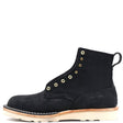 A black suede ankle boot with gold-tone metal eyelets, a pull tab, and a thick off-white sole, shown from a side profile on a white background.