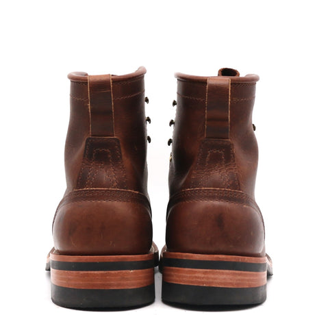 A pair of brown leather lace-up boots shown from the back, featuring a thick black and tan sole, photographed against a solid white background.