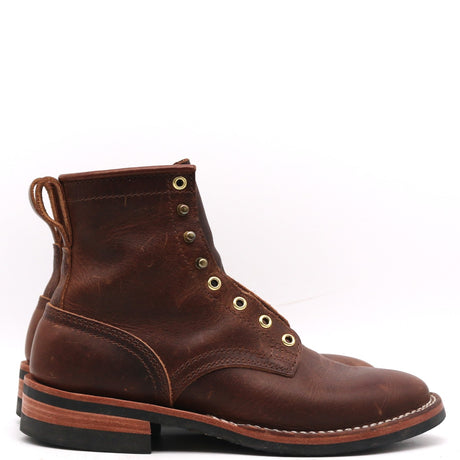 A dark brown leather lace-up ankle boot with brass eyelets and a pull tab, shown from a side profile on a white background.