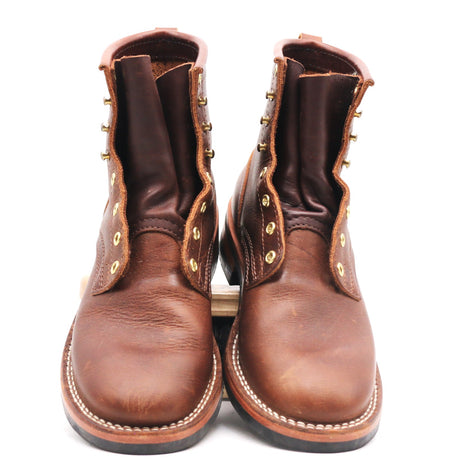 A pair of brown leather lace-up ankle boots with brass eyelets and white contrast stitching, photographed against a plain white background.