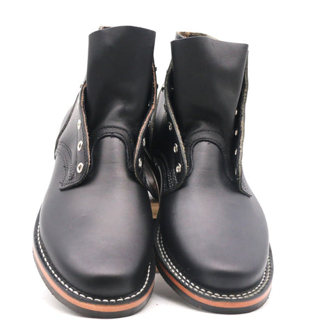A pair of black leather ankle boots with silver metal eyelets and white contrast stitching, photographed against a plain white background.