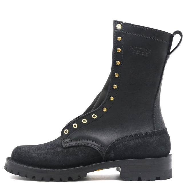 A black leather and suede combat boot with gold-tone metal eyelets and studs, shown from a side profile on a white background.