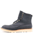 A single dark navy suede lace-up ankle boot with brass eyelets and a light tan sole, shown from a side profile on a white background.