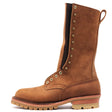 A tall brown suede lace-up work boot with brass eyelets, a pull loop, and a thick lug sole, shown from a side profile on a white background.