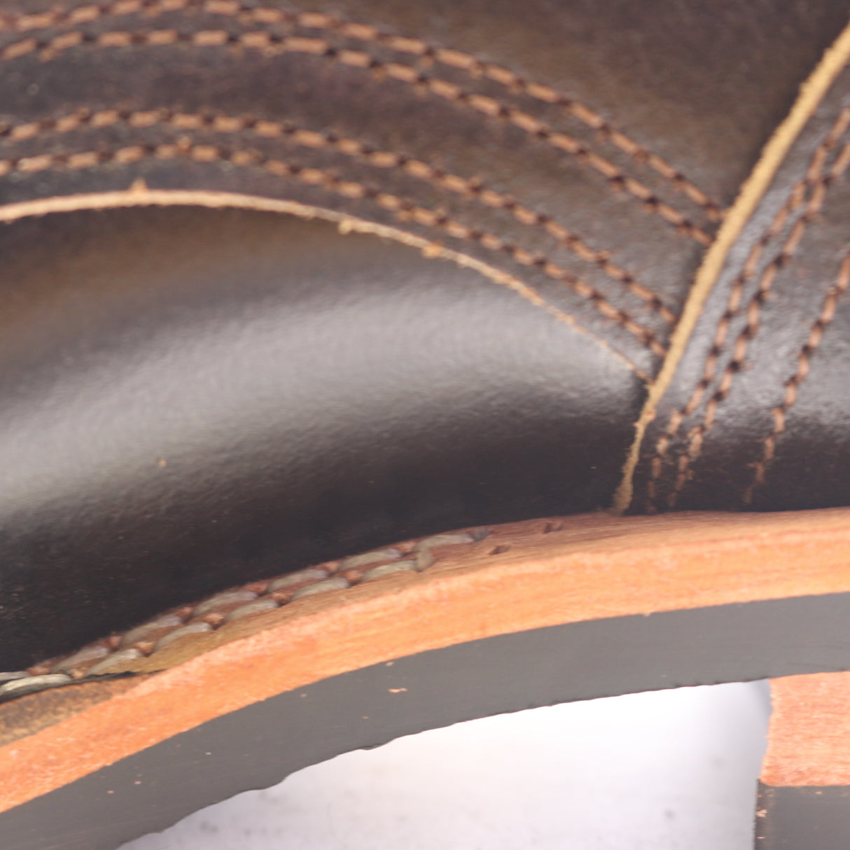 Close up of the inside of a boot showing extra sewing holes along the sole stitching.