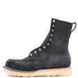 A single black suede ankle boot with gold-tone metal eyelets and studs, a pull tab, and a light tan sole, shown from a side profile on a white background.