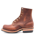 A single brown leather lace-up ankle boot with brass grommets, a stacked wood-look heel, and a black outsole, shown from a side profile on a white background.