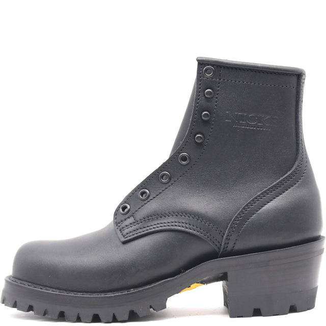 A black leather ankle boot with a chunky lug sole and a low block heel, featuring metal eyelets and a debossed 'KICKS' logo on the side, shown against a plain white background.
