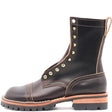 A dark brown leather lace-up boot with gold-tone metal eyelets, a chunky lug sole, and a tan midsole layer, shown from a side profile on a white background.