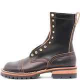 A dark brown leather lace-up boot with gold-tone metal eyelets, a chunky lug sole, and a tan midsole layer, shown from a side profile on a white background.