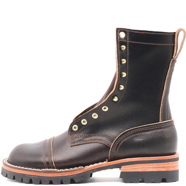 A dark brown leather lace-up boot with gold-tone metal eyelets, a chunky lug sole, and a tan midsole layer, shown from a side profile on a white background.
