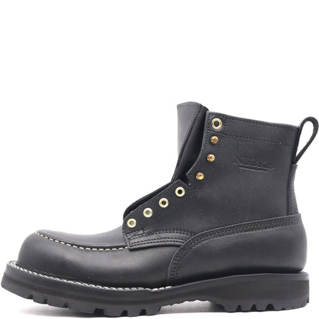 Black ankle boot with a moccasin toe, brass hardware, padded gusset, and comfort flex notches in front of a white background
