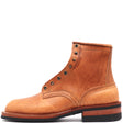 A single light brown leather lace-up boot with brass eyelets and a stacked black and brown sole, shown from a side profile on a white background.
