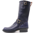 A dark navy blue leather mid-calf boot with gold-tone buckle straps and a black stacked heel, shown from a side profile on a white background.