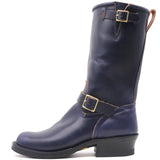 A dark navy blue leather mid-calf boot with gold-tone buckle straps and a black stacked heel, shown from a side profile on a white background.