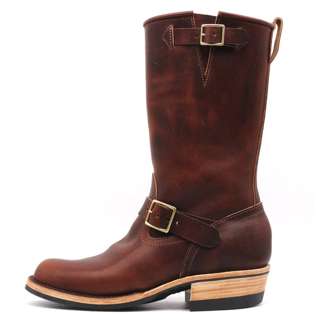 A dark brown leather mid-calf boot with brass buckle straps, a stacked wood-look heel, and a black outsole, shown from a side profile on a white background.