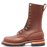 A brown leather work boot with brass eyelets and studs, featuring a pull tab and a thick black lug sole, shown against a plain white background.