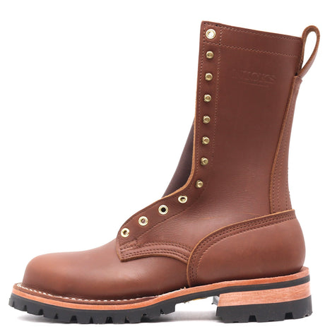 A brown leather work boot with brass eyelets and studs, featuring a pull tab and a thick black lug sole, shown against a plain white background.