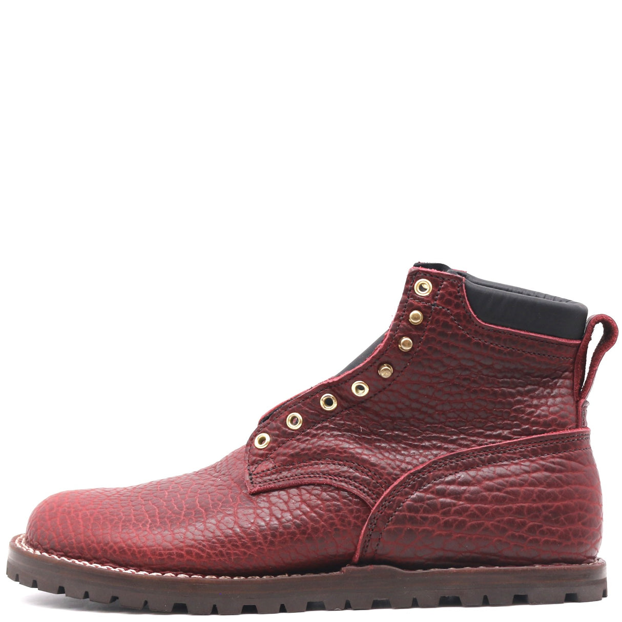 A single red textured leather lace-up ankle boot with gold-tone metal eyelets, a black collar lining, and a dark brown lug sole, shown from a side profile on a white background.