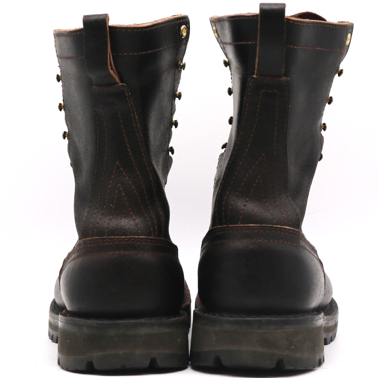 Pair of brown leather boots shown from behind. Heel counters and two-piece backstays are visible in front of a white background.