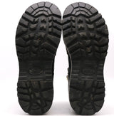 Pair of worn black outsoles with pronounced tread shown against a white background.