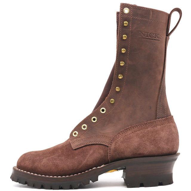 A brown suede and leather lace-up boot with brass eyelets, a pull tab, and a chunky dark sole, shown from the side on a white background. The brand name 'NICK' is embossed on the side.