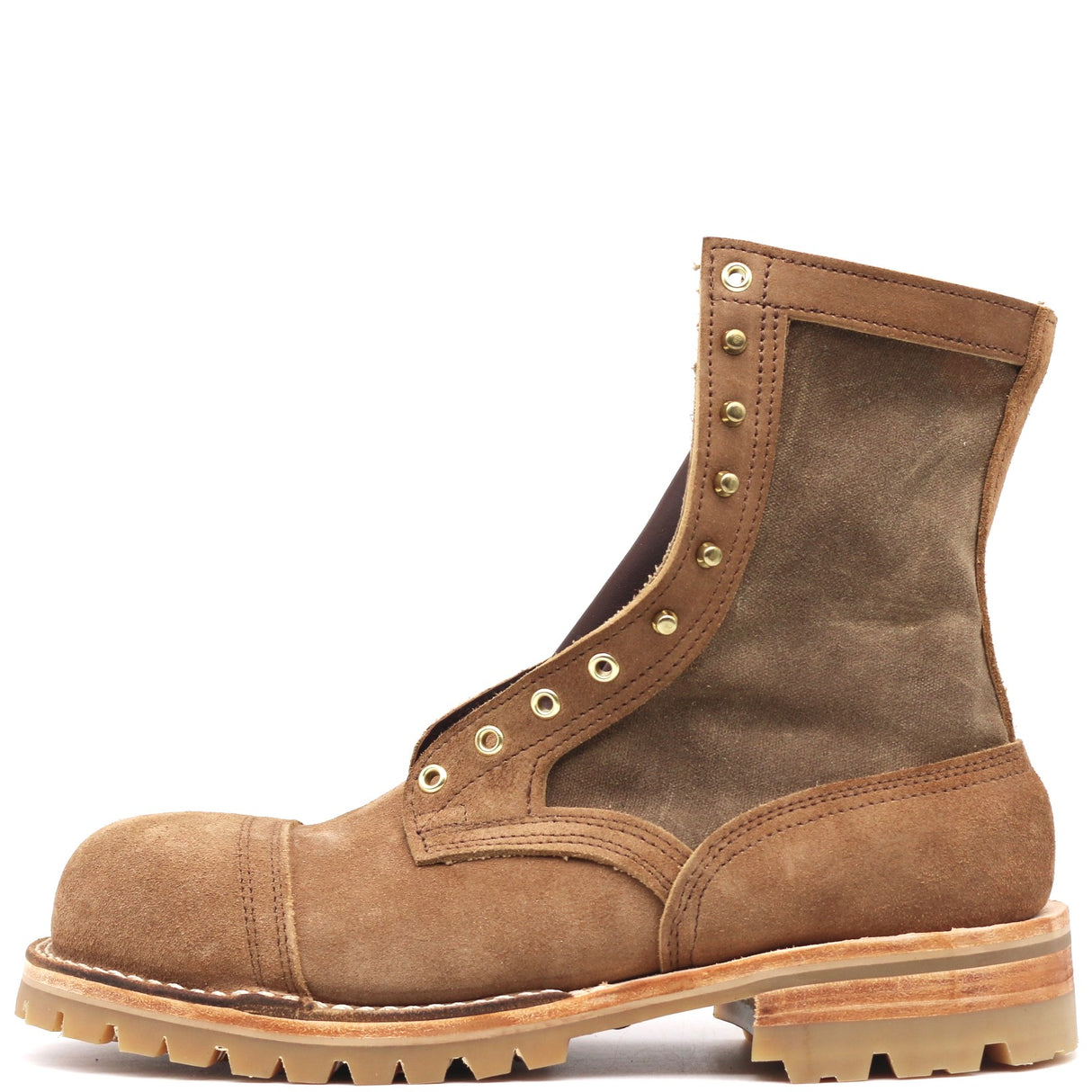 Photograph of one single tan leather boot with canvas uppers, a 4 row toecap, composite safety toe, and brass hardware in front of a white background.