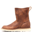 Photo of a brown pull-on boot with a white wedge outsole and a rear pull loop in front of a white background.