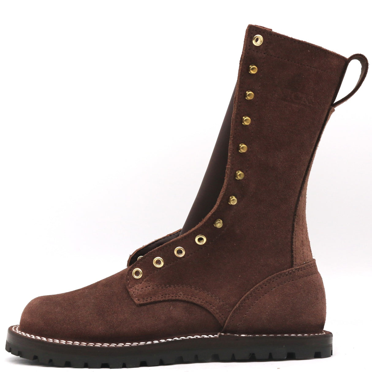 Photo of a single tall brown boot with a flat outsole and brass hardware in front of a white background.
