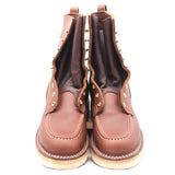 Pair of brown moccasin toe boots shown from the front and front a slightly elevated height in front of a white background. Boots show signs of light wear.