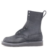 Black leather boot with a black wedge outsole, black hardware, a tactical heel counter and pull loop in front of a white background.