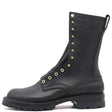 Tall black fire boot with Red-X lug outsole burn resistant sole stitching, and brass hardware in front of a white background.