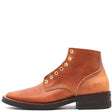 Five inch brown leather dress boot with brass eyelets in front of a white background.