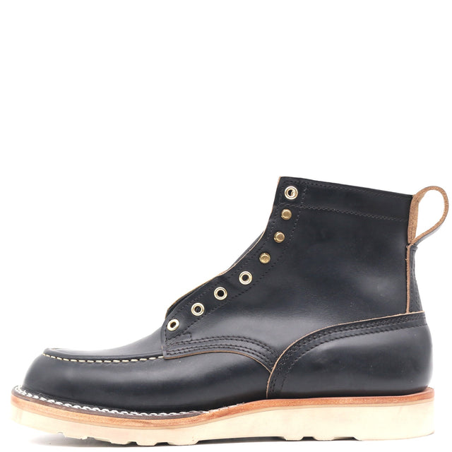 Black leather boot with a moccasin toe, brass hardware, and a white wedge outsole shown from the side profile in front of a white background.