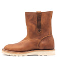 Photograph of a brown pull on boot with side pull loops and a white wedge outsole in front of a white background.
