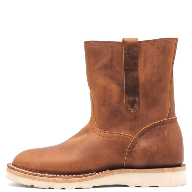 Photograph of a brown pull on boot with side pull loops and a white wedge outsole in front of a white background.