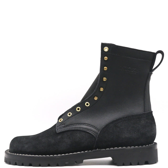Black leather boot with a near zero drop unit lug outsole and brass hardware in front of a white background.