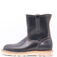 Dark brown leather pull on boot with side pull loops and a white wedge outsole in front of a white background.