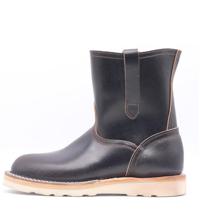 Dark brown leather pull on boot with side pull loops and a white wedge outsole in front of a white background.