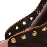 Close up photo on the hardware of a boot. The third eyelet from the bottom is visibly mismatched from the rest of them.