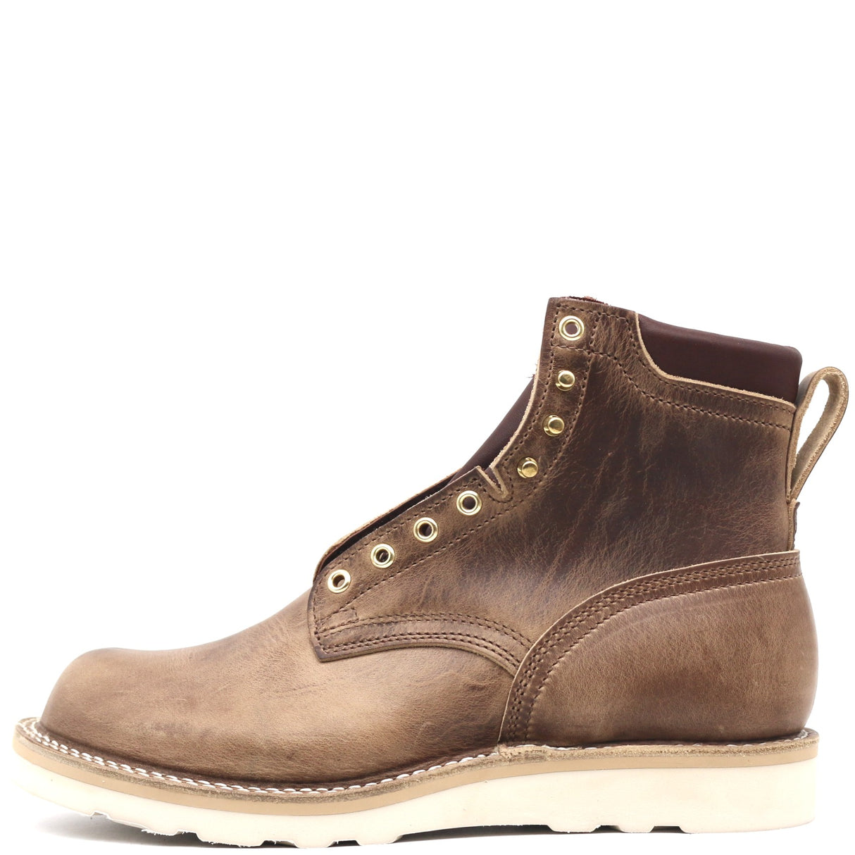 A brown leather lace-up ankle boot with brass eyelets, a pull tab, and a thick off-white sole, shown from a side profile on a white background.