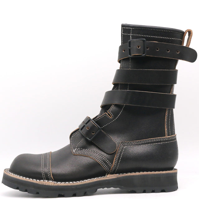 A black leather mid-calf boot with multiple adjustable straps and contrast stitching, shown from a side profile on a white background.