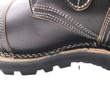 Close-up of a black leather boot showing the side panel, white contrast stitching, and rugged black sole against a white background.