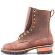 Brown suede eight inch leather boot with padded gusset and brass hardware in front of a white background.