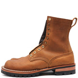 A single brown leather work boot with metal eyelets, a pull tab, and a black lug sole, shown from a side profile on a white background.