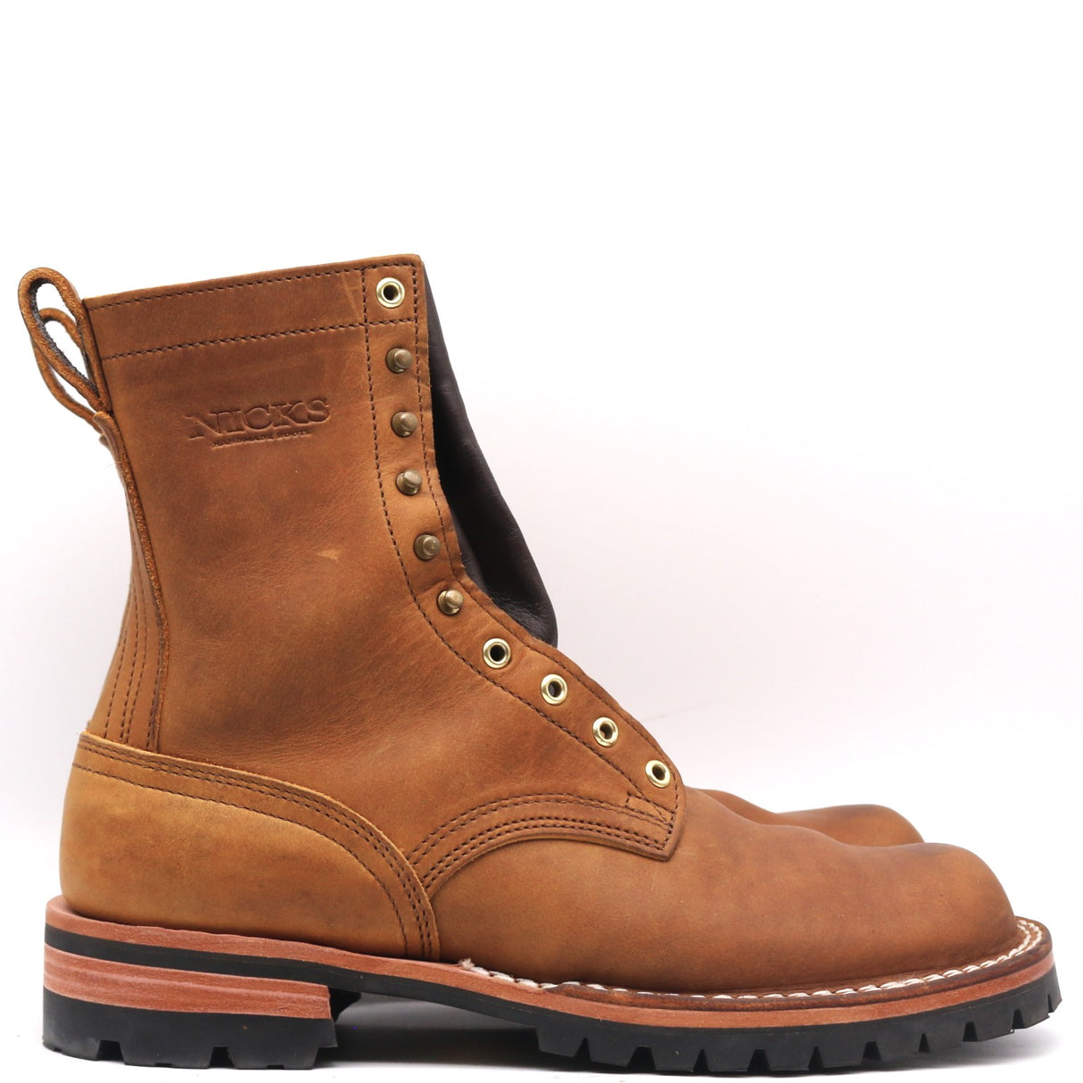 A single brown leather work boot with metal eyelets, a pull loop, and a black lug sole, photographed on a clean white background.