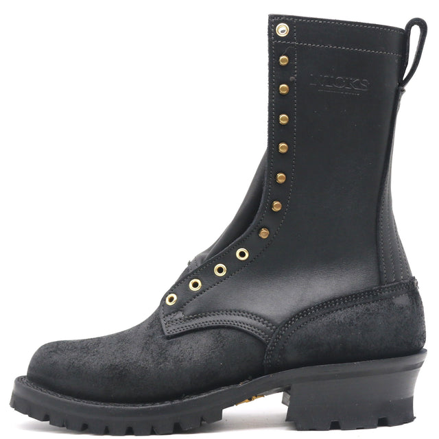 A black leather and suede lace-up work boot with gold-tone metal eyelets and studs, featuring a pull tab and a rugged lug sole, shown against a plain white background.