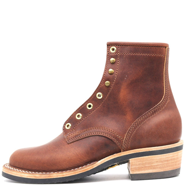 A brown leather ankle boot with a stacked wood-look block heel, black outsole, and brass eyelets, shown from a side profile on a white background.